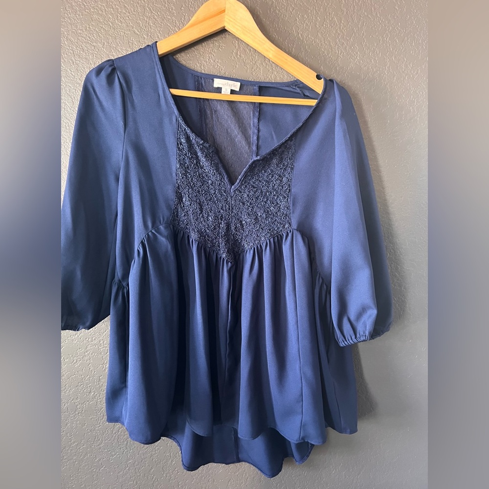 Woman’s navy blouse with lace detail